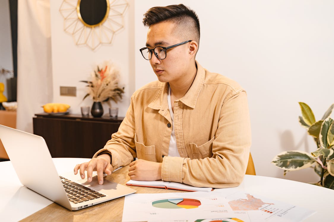 Person working on a laptop to complete a task, illustrating instruction driven searches.