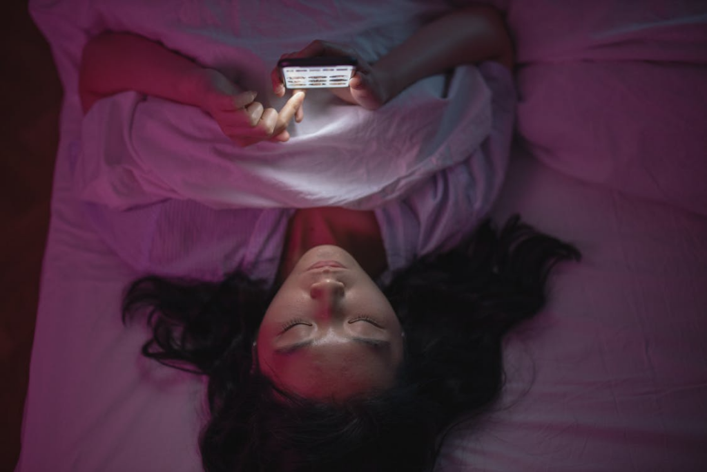 Browsing vs decision searches shown by a person scrolling on a smartphone in bed at night.