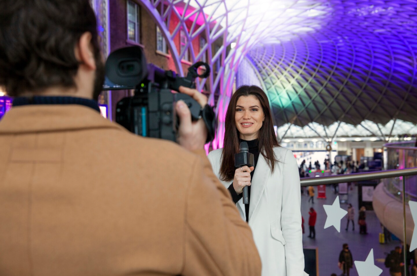 Real-world events behind searches shown as a reporter covers a live public announcement.