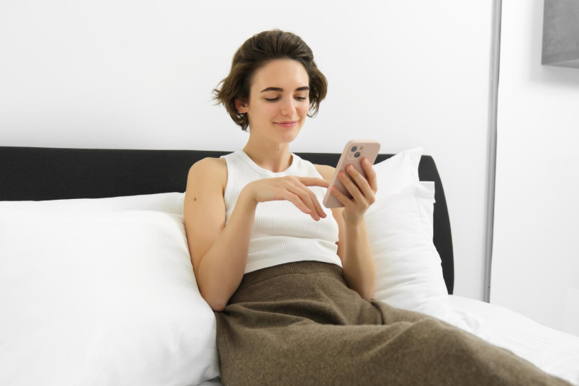 Person checking a phone after waking up, illustrating overnight search trends.